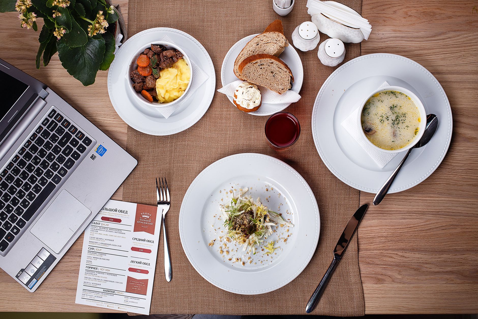 Soup, salad and a midday plate on a pale cloth